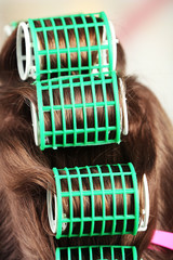 Long female hair during hair dressing with curler, close-up,