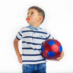 Caucasian boy holding a soccer ball and whistle