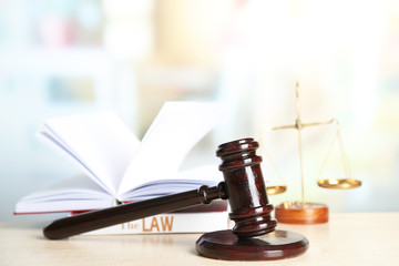 Wooden judges gavel on wooden table, close up