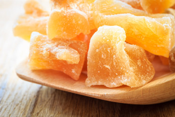 Closeup candied ginger on wooden spoon