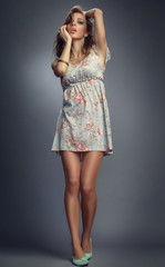 model advertises clothes in the studio on a black background