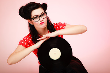 Retro music. Pinup girl with vinyl record