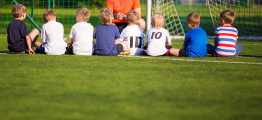 Football soccer match for children. Kids breiefing with trainer