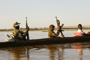 African soldier during operation - transported by traditional ca