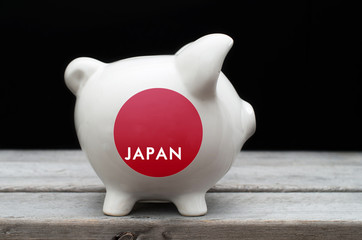 Japanese economy concept with a piggy bank painted with Japan fl