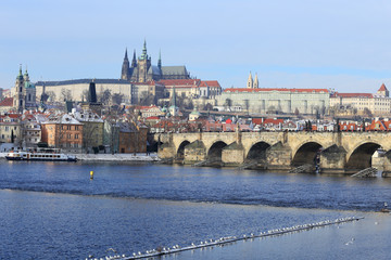 Fototapeta premium Snowy Prague gothic Castle with Charles Bridge, Czech Republic