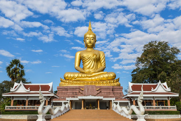 big  golden buddha statue sitting in thai temple