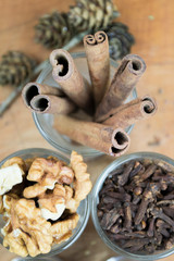Glasses of  spices, cinnamon, nuts, allspice, sesame on a wooden
