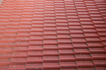 Red roof tile pattern over blue sky