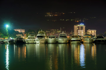Fototapeta na wymiar Yacht on the sea pier at night