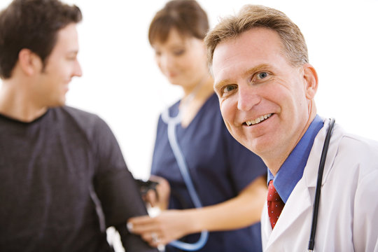 Doctors:  Cheerful Doctor with Patient and Nurse