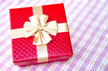 red gift box with gold ribbon