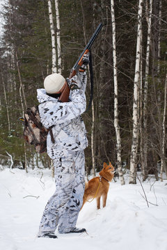 hunter shooting in winter forest
