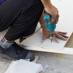 carpenter hands using electric drill on wood