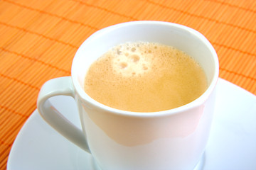 Cup of coffee on wooden background.