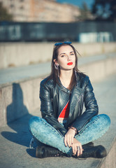 Young fashion beautiful girl in leather jacket outdoor