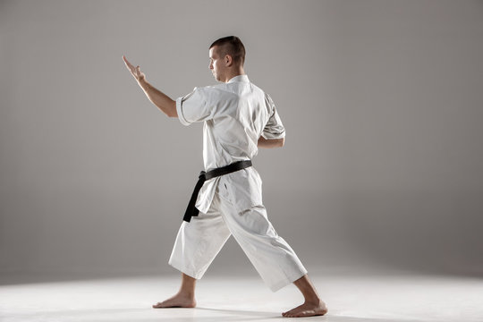 Man in white kimono training karate