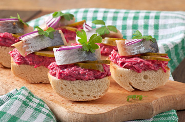 Sandwiches with herring, beetroot and pickled cucumber