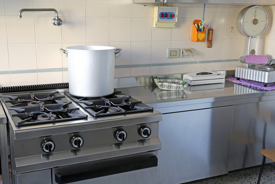industrial kitchen with gas stove and the giant aluminum pot
