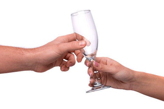 Hand giving a champagne flute