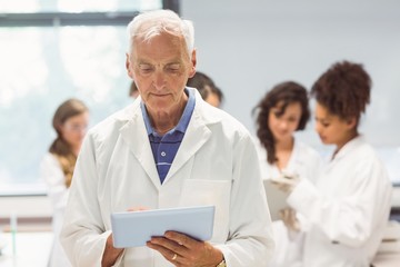 Fototapeta premium Science lecturer holding tablet pc in lab