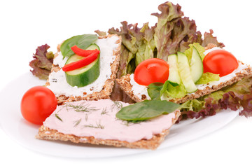 Cracker with fresh vegetables and cream