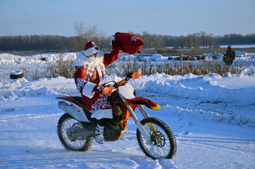 On a motorcycle motocross Santa Claus welcomes
