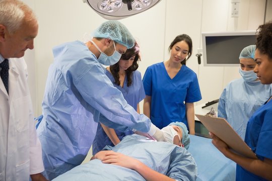 Medical students learning from professor