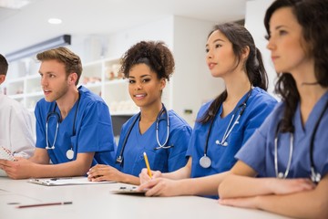 Medical student smiling at the camera during class