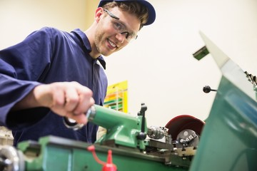 Engineering student using heavy machinery