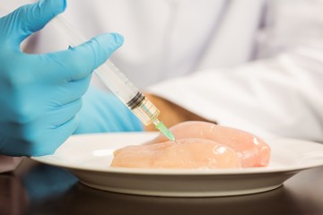 Food scientist injecting raw chicken © WavebreakmediaMicro
