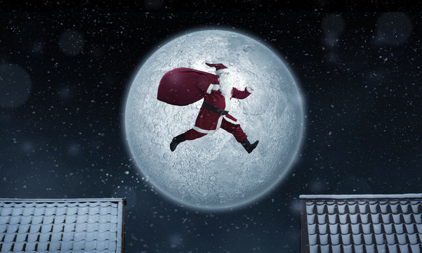 Santa Claus jumping between rooftops at night