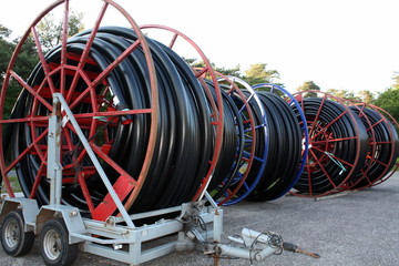 Red cable drums with black cable