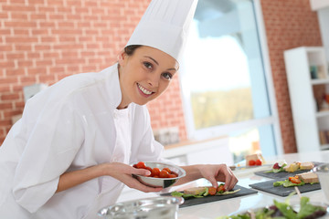 Smiling cook preparing appetizer