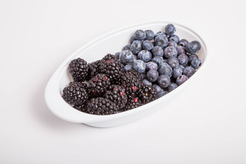 Blackberries and Blueberries in White Dish on White Background