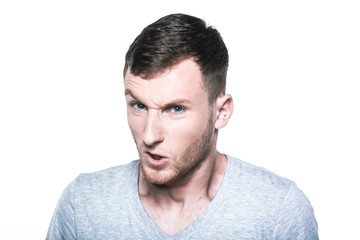 Fototapeta premium Very angry young man on whited