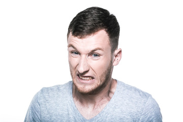 Very angry young man on whited