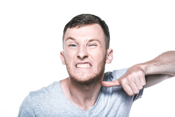 Fototapeta premium Very angry young man on whited