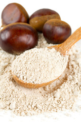 chestnut flour in a wooden spoon isolated on white