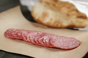 dried salami sausage on paper ready for sandwich