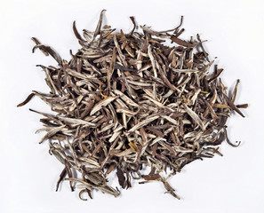 Heap of green tea leaves on a white