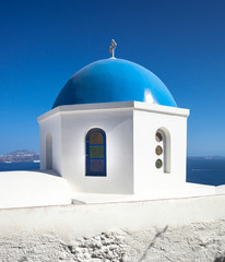 Fototapeta na wymiar Church with blue cupola at Oia Village, Santorini island.