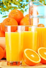 Composition with glasses of orange juice and fruits