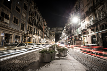 Cars, houses and lights in the street the night Porto. Toned
