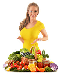 Young woman with assorted grocery products isolated on white