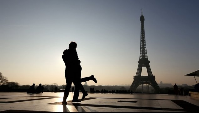 silhouettes of romantic couple near Eiffel Tower, Paris, France