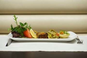 Aegean-style vegetables on white plate with cutlery