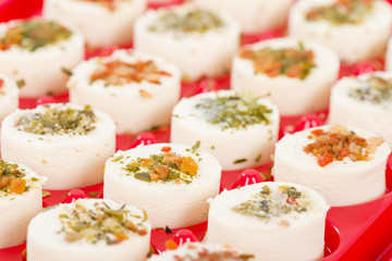 Cheese Appetisers - Soft cheese topped with herbs and spices.