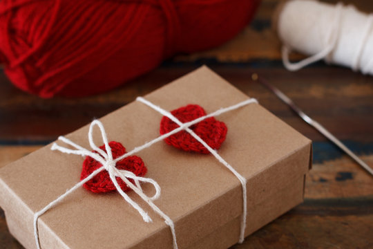 Saint Valentine decoration: handmade crochet red heart on gift p
