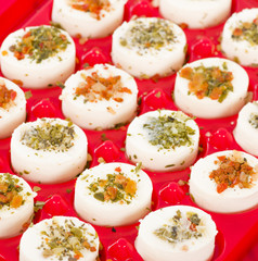 Cheese Appetisers - Soft cheese topped with herbs and spices.